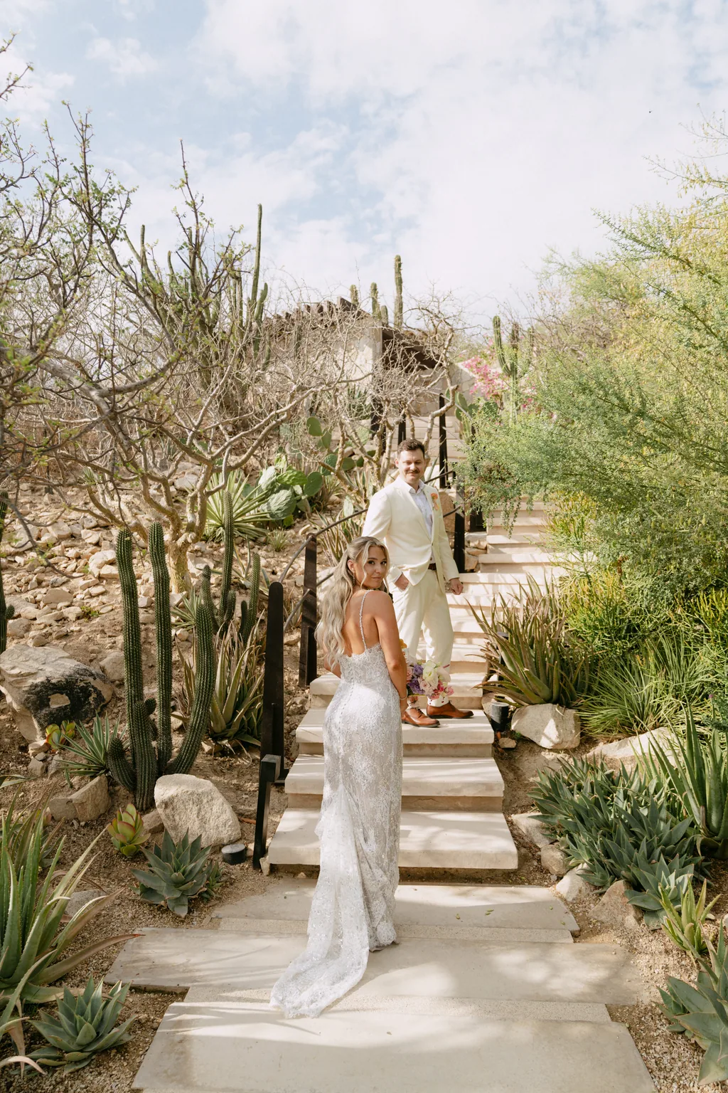 Bailey walking up the cactus steps with her train behind her