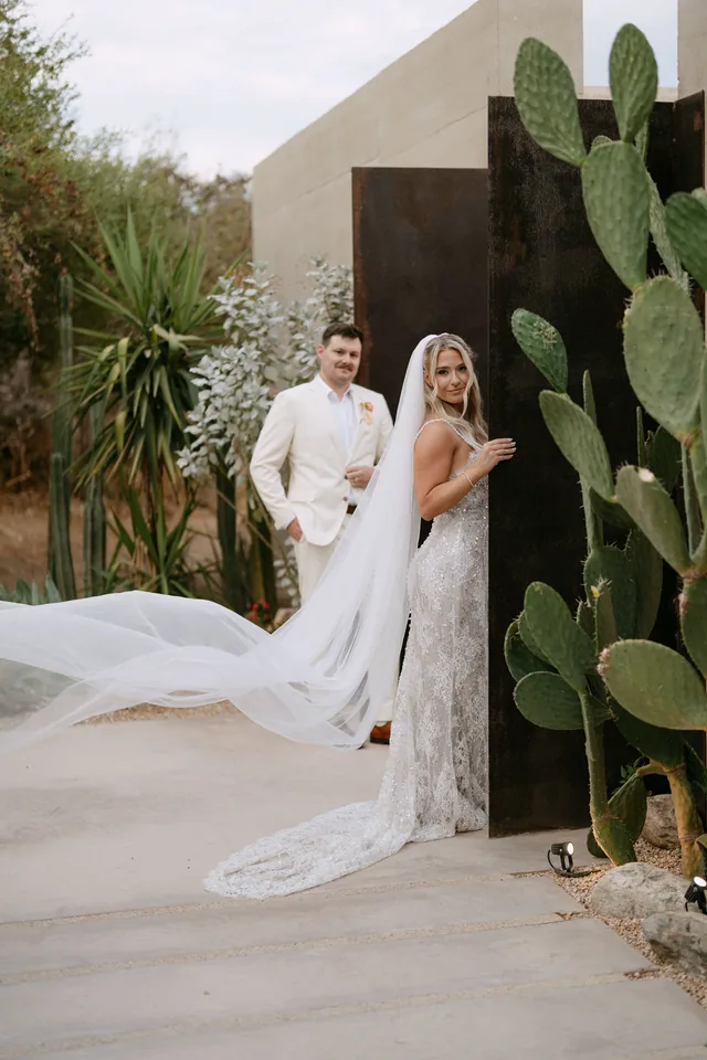 Bailey's veil flying across the frame beside the cactus garden at Acre