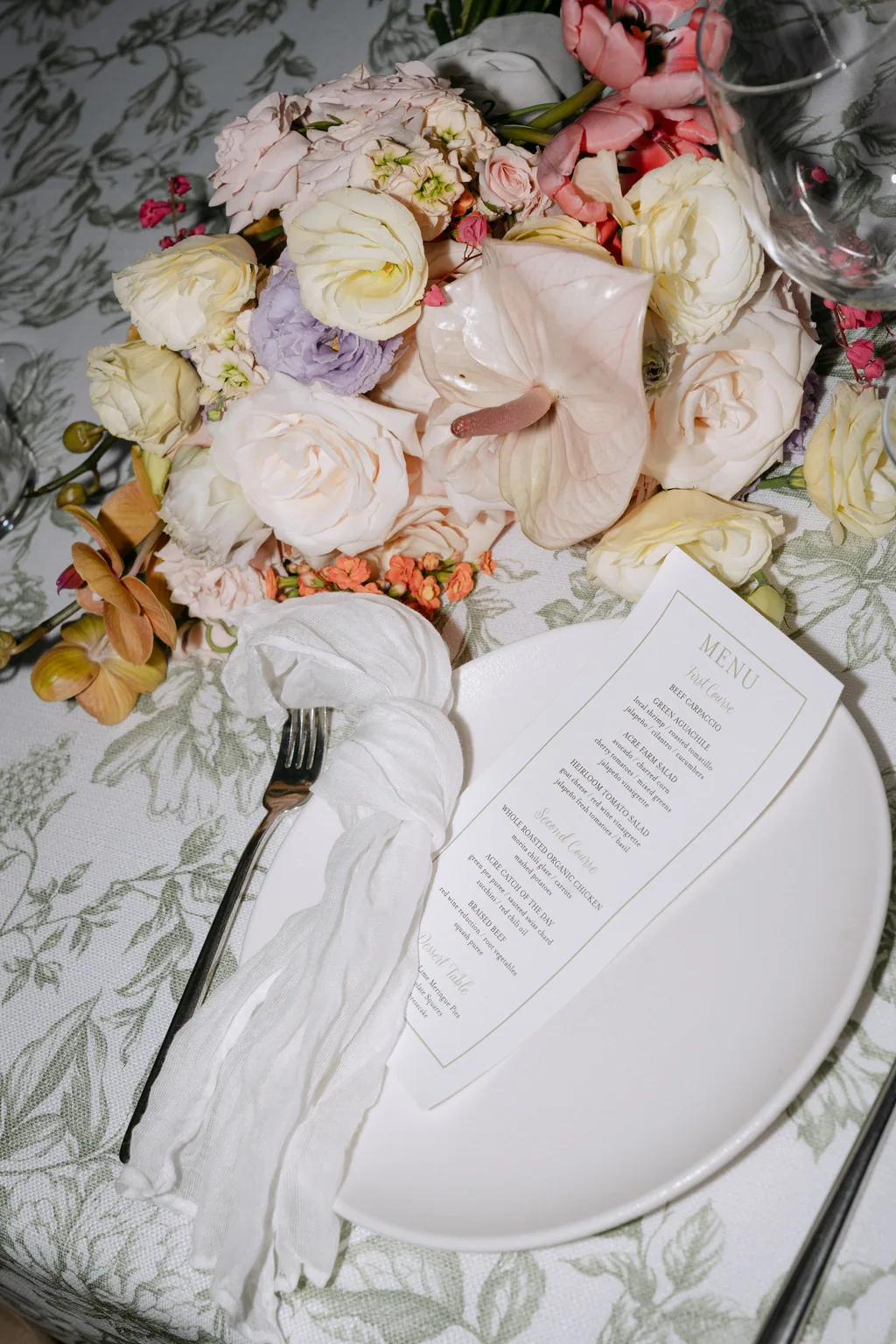 Bailey's bouquet resting on the table beside a place setting