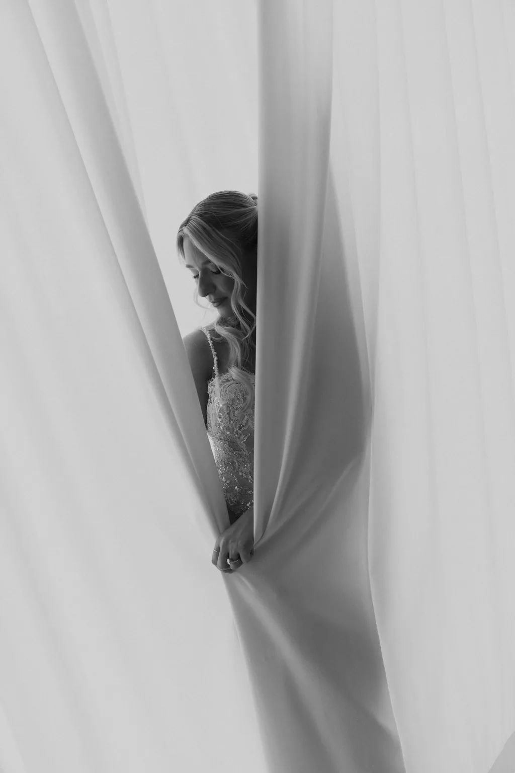 Bailey in silhouette against the curtain, in black and white