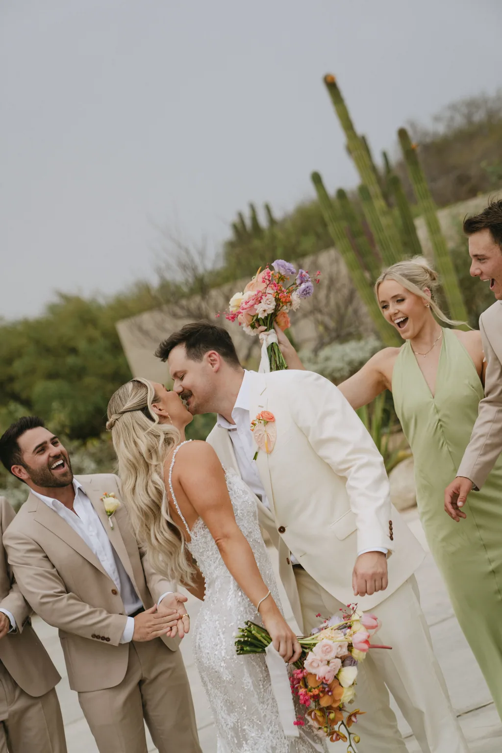 The whole wedding party walking together and laughing at Acre