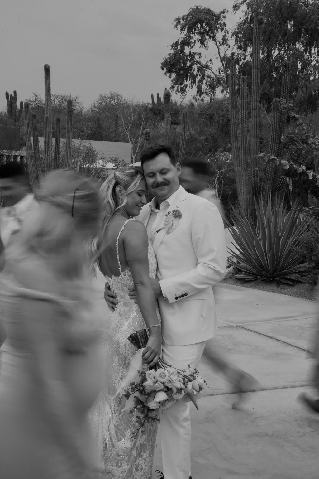 Bailey and Matthew still while everyone blurs around them, in black and white