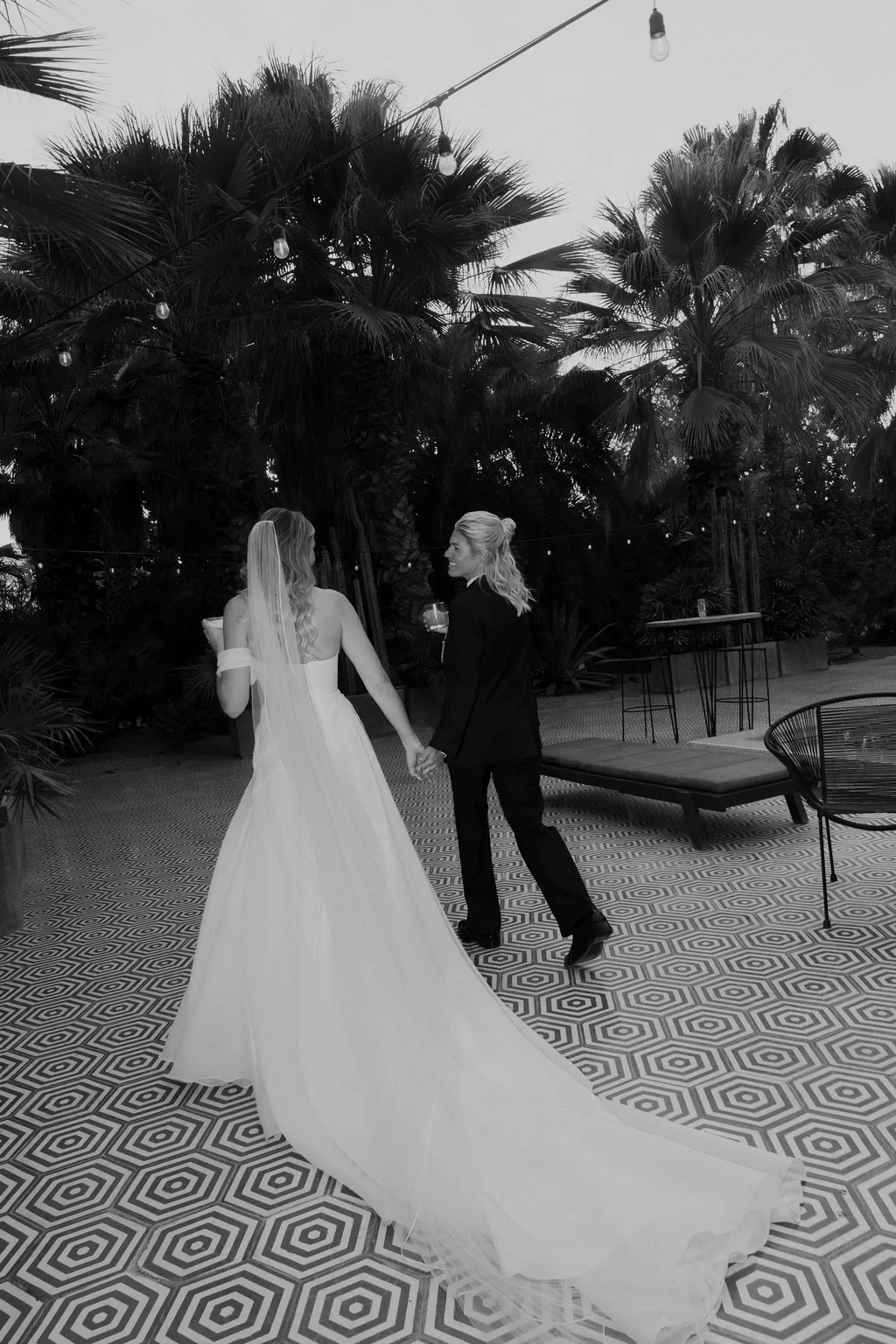 The two of them and the train across the tile, in black and white