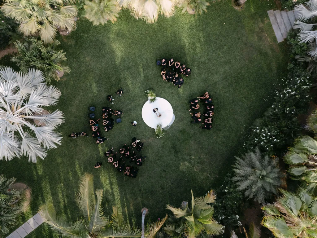 The ceremony from above: the white circle on the grass and everyone in black around it