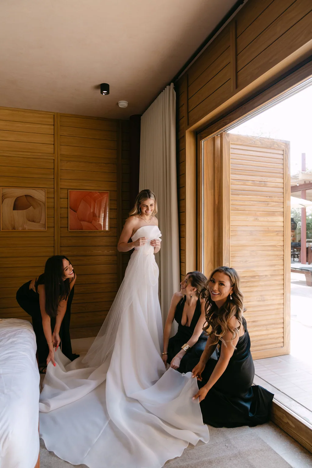Her friends arranging the dress in the room