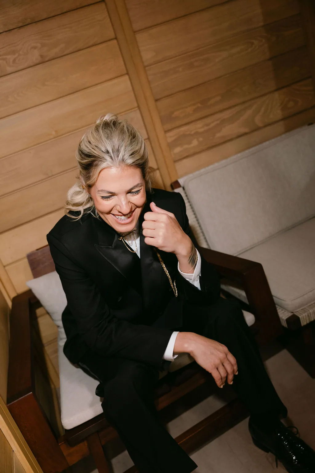 The bride in the tuxedo seated, before the ceremony