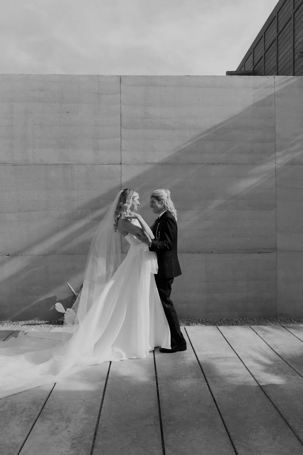 The two of them in the concrete corridor, in black and white