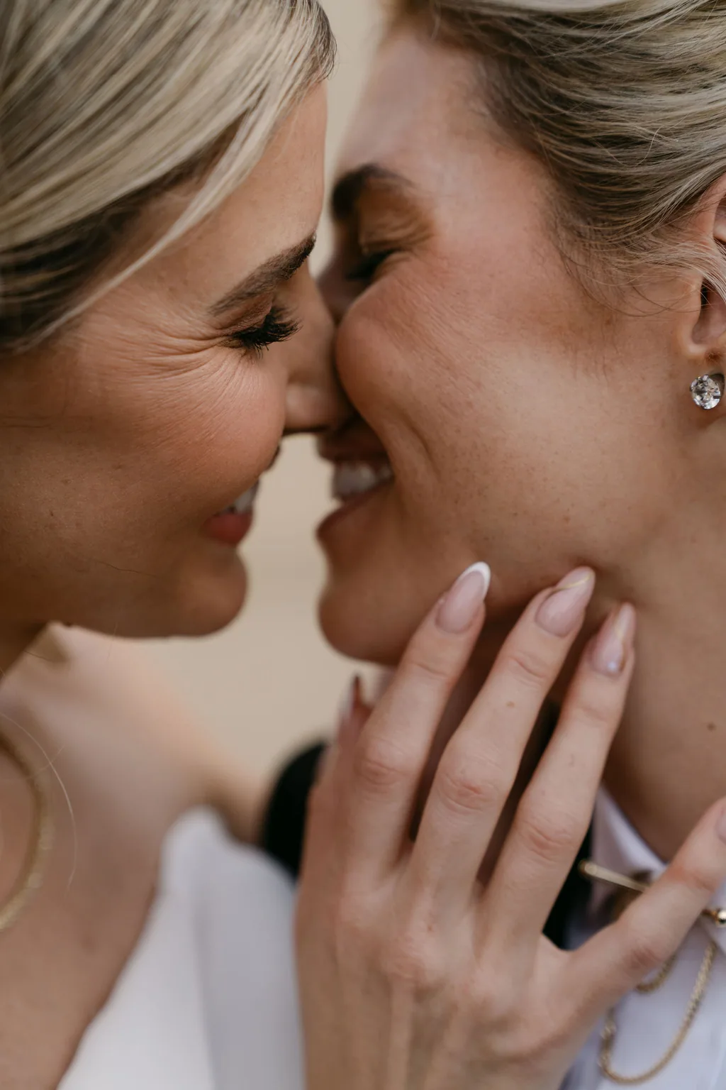 Emma and Whitney nose to nose, hands on each other