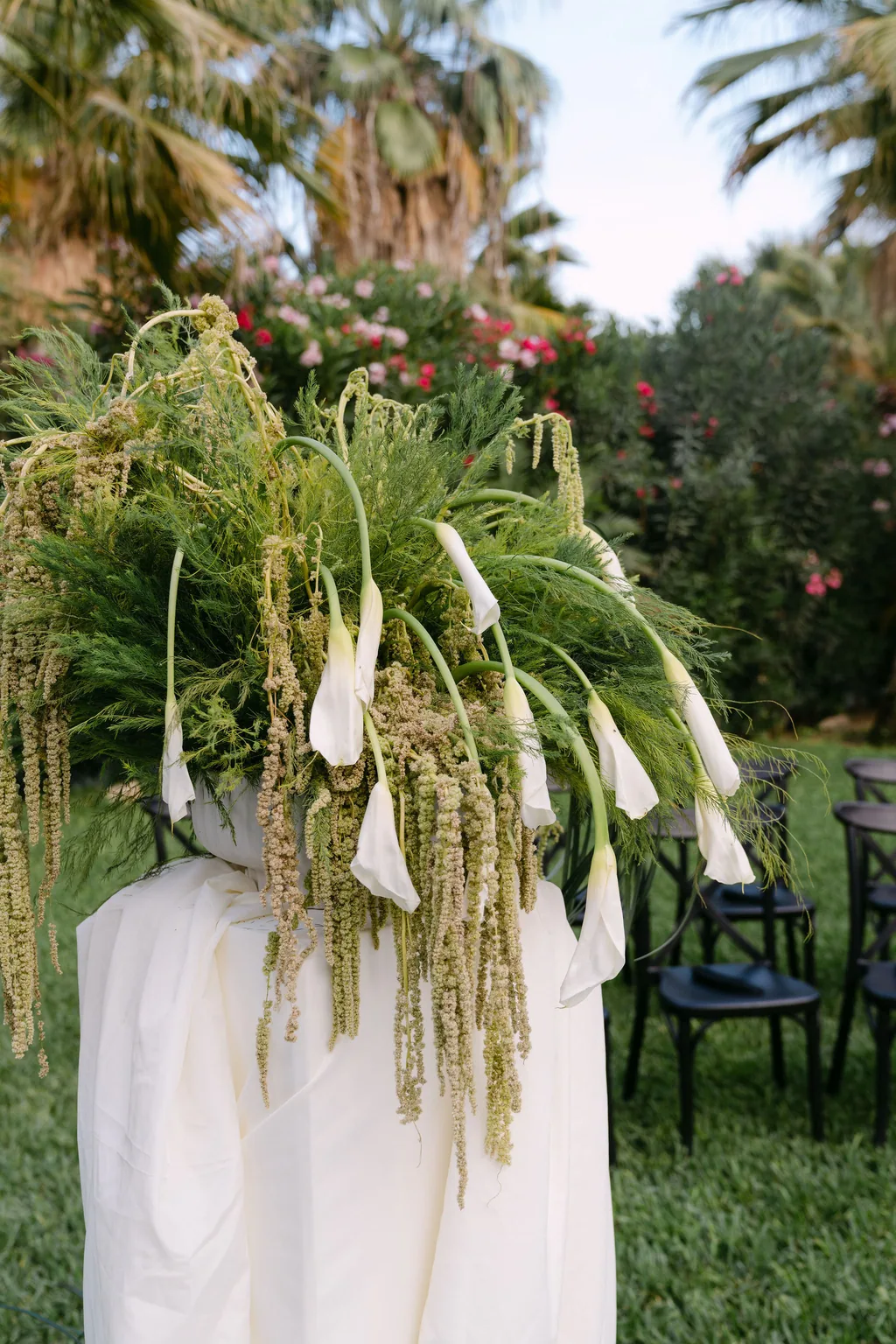 The ceremony flowers: white callas and hanging amaranthus