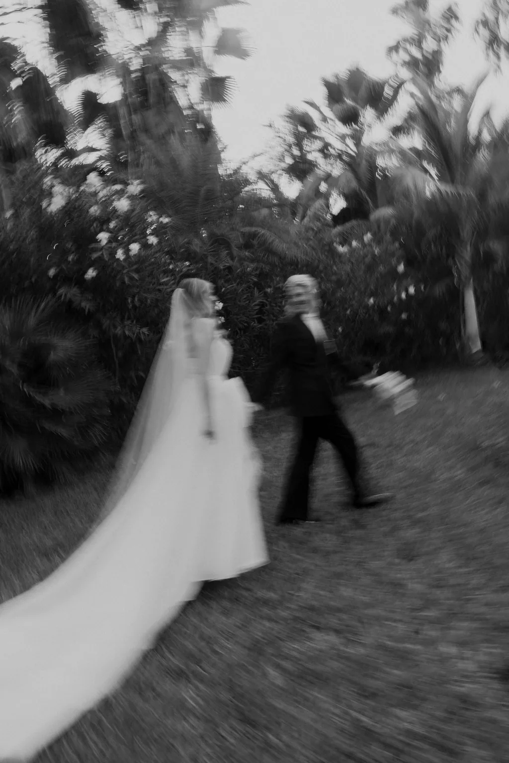 The two of them walking, blurred, in black and white