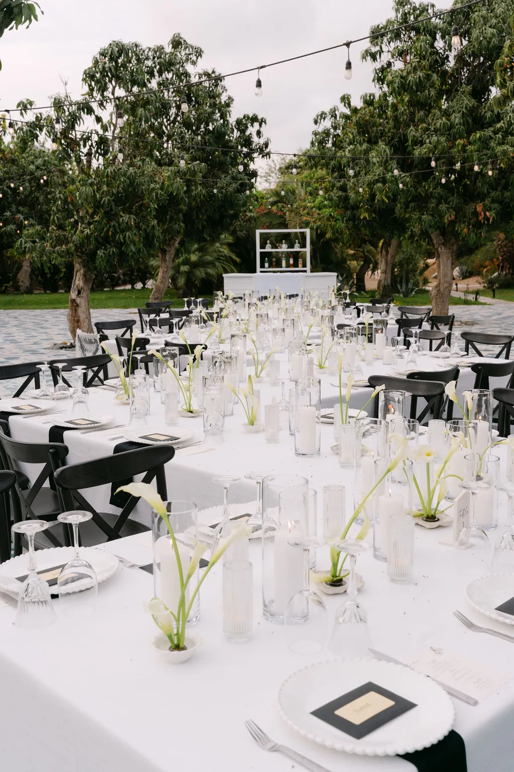 The reception tables set with white callas at dusk