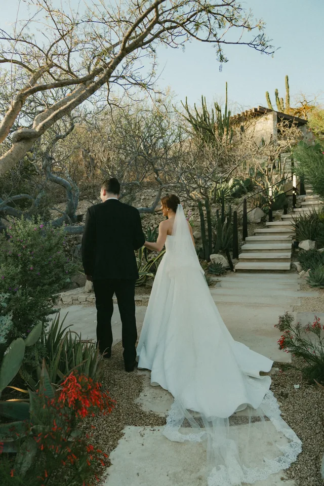 Lauren and Tevyn on the stone stairway through the garden, with bougainvillea