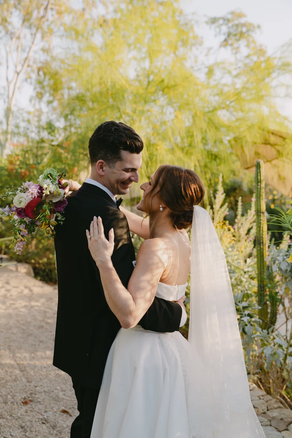 Lauren and Tevyn in the last of the light, with the red flowers behind them
