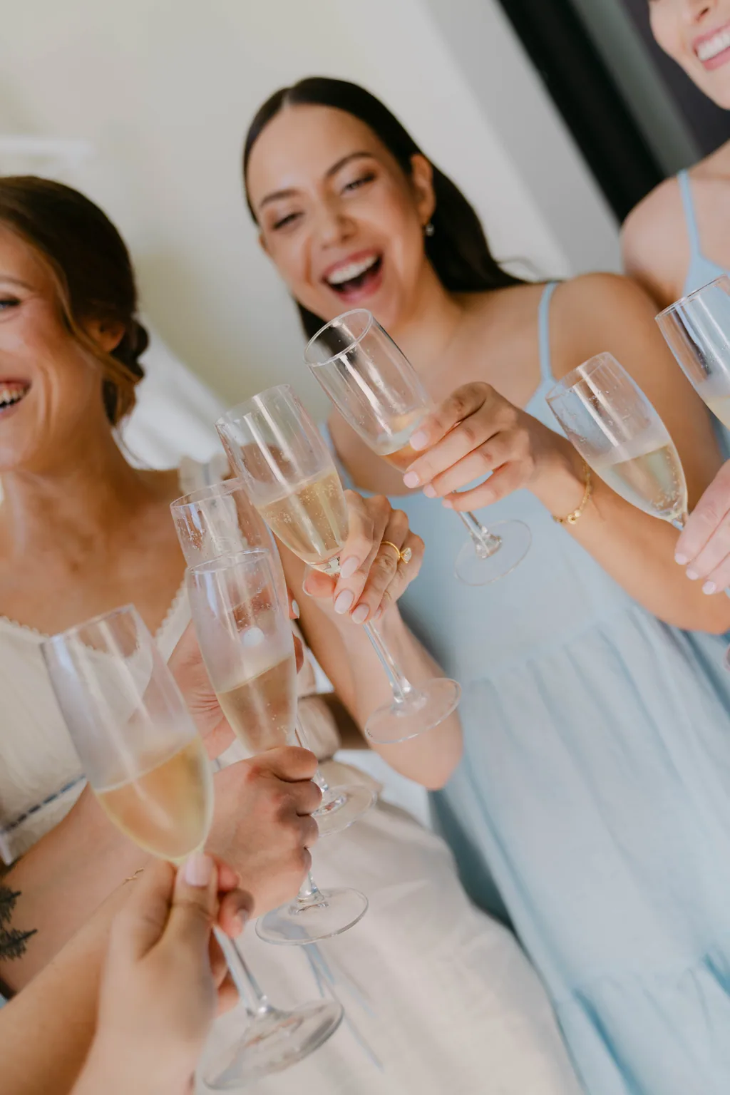 The bridesmaids raising a toast together in the room