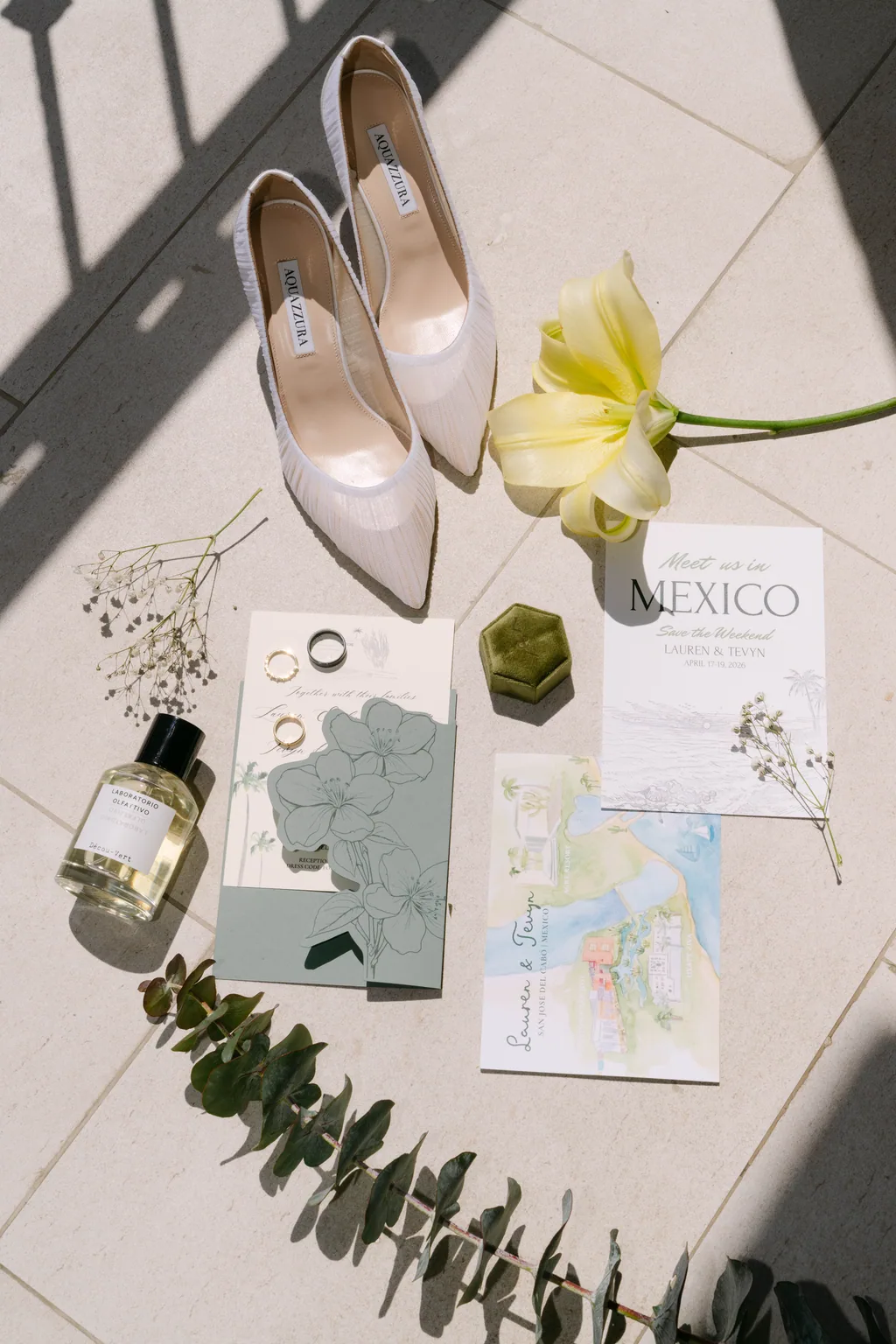 The rings, the perfume, the invitation and a yellow flower in the morning light