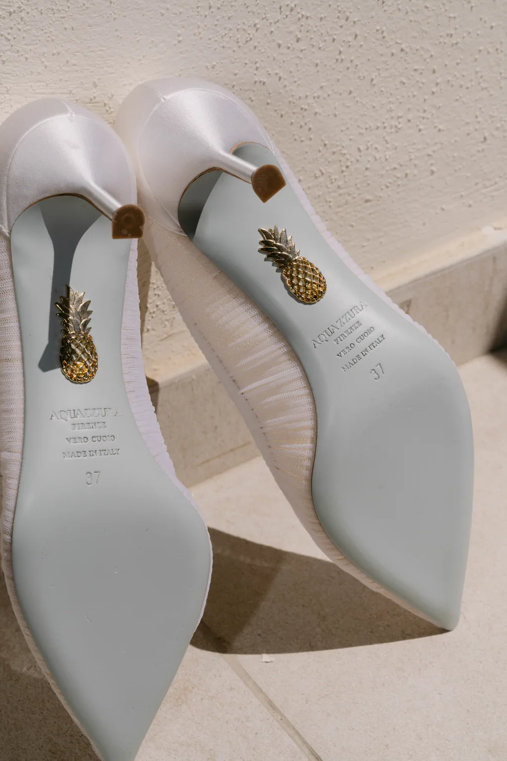 A pineapple drawn on the sole of her wedding shoes