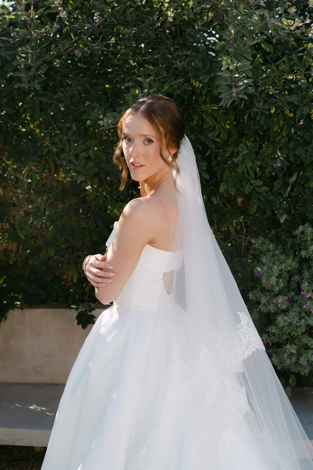 Lauren in the sun with her veil, looking back