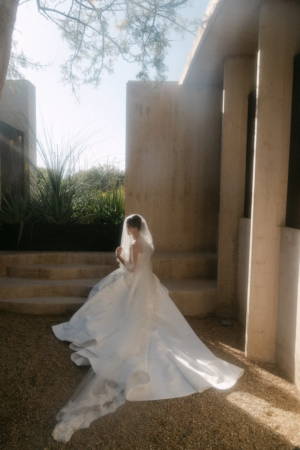 Lauren running through the concrete corridor with her veil behind her