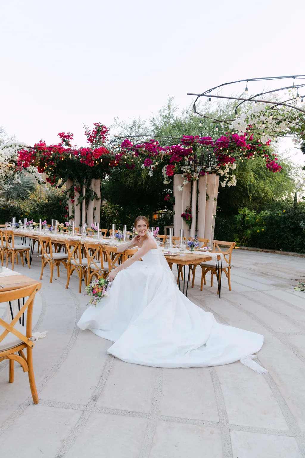 Lauren walking into the reception under the bougainvillea